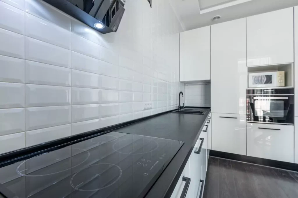 Subway tile kitchen with graphite counter tops channeling nyc energy